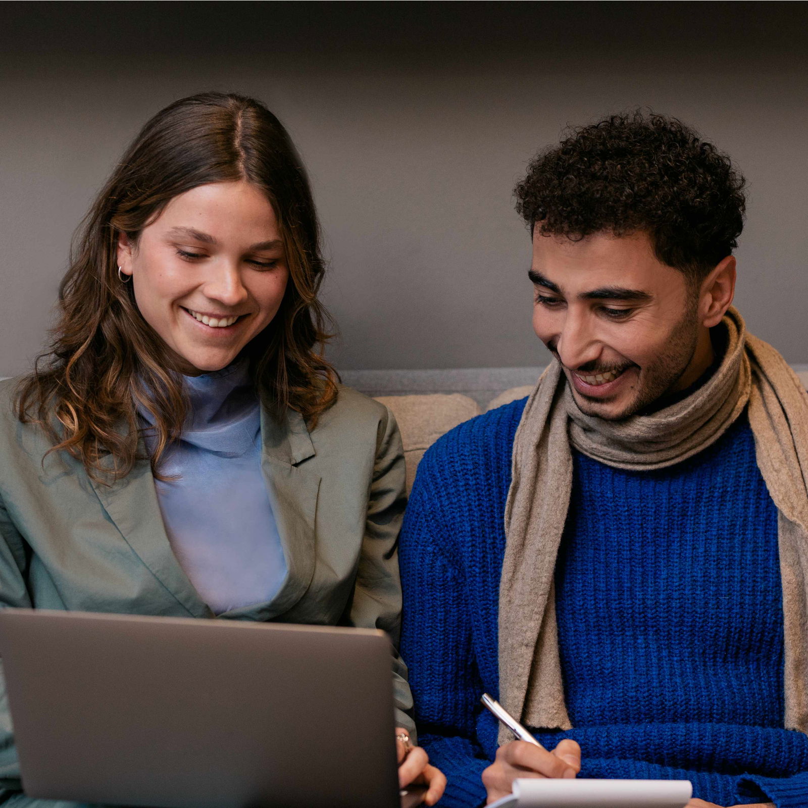 Woman and man looking together on a laptop screen