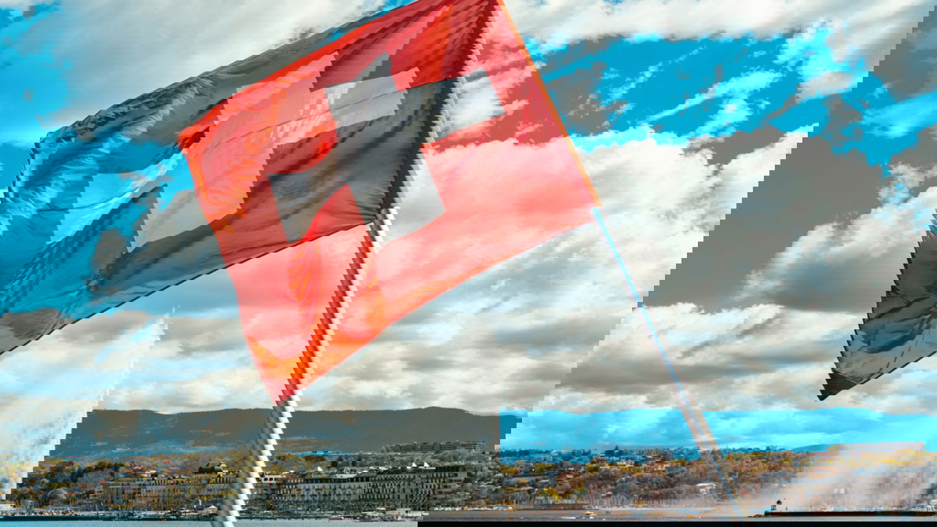 visa-switzerland.jpg A swiss flag at the lake of Genf